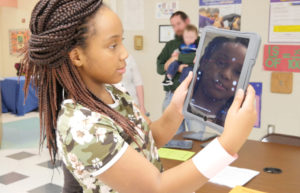 Child looking at ipad displaying astronomy app