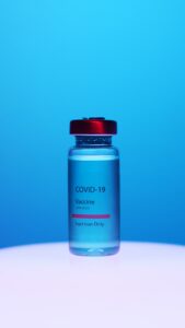 The image is an injection vial that reads COVID-19 vaccine injection only