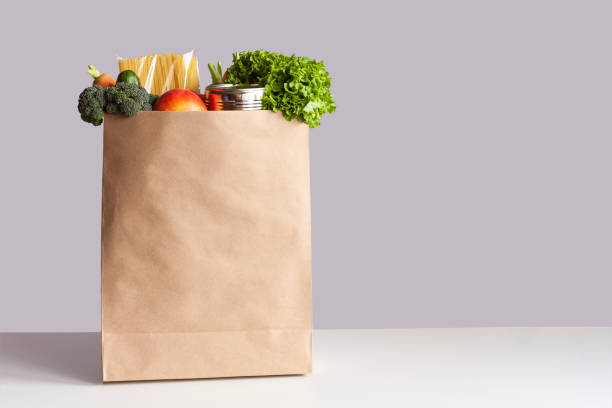 Brown paper bag full of grocery items.